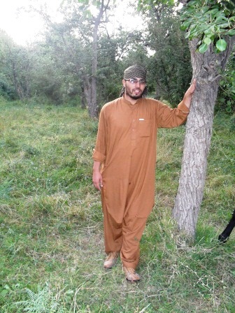 Ahmad Mujtaba standing beside the tree